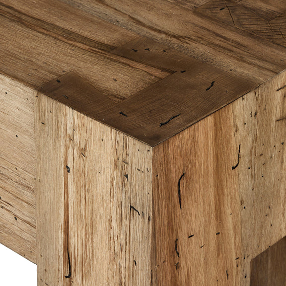 Close-up of Abaso Accent Bench corner, showcasing thick-cut oak veneer with rustic wormwood finish. Visible are clean Parsons lines, chunky squared legs, and intricate dovetail joinery detailing, highlighting the bench's craftsmanship and natural wood grain texture.